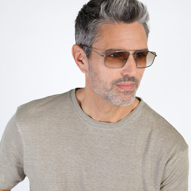 Model with salt and pepper beard looking left wearing Jane Sunglasses Gunmetal with Taupe Gradient