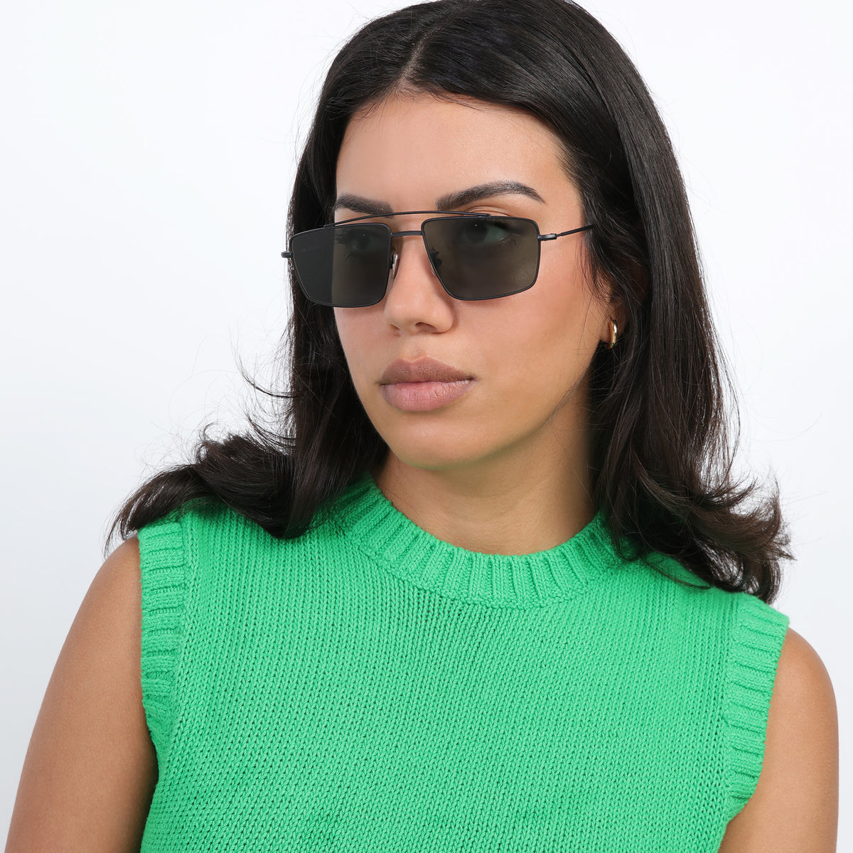 Woman wearing Jane Sunglasses in Matte Black with Olive lenses, Brunette model with loose curls looking right