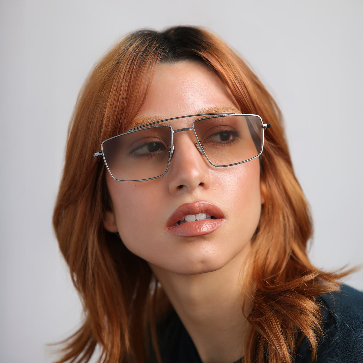 Woman wearing Jane Sunglasses in Gunmetal with Taupe Gradient lenses, Model with red hair