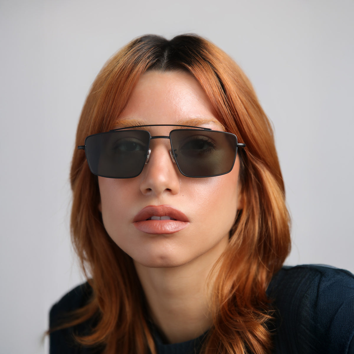 Woman wearing Jane Sunglasses in Matte Black with Olive lenses, Another angle of model with red hair