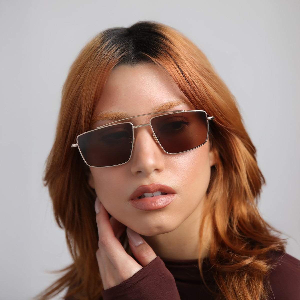 Woman wearing Jane Sunglasses in Rose Gold with Brown lenses, Model with red hair
