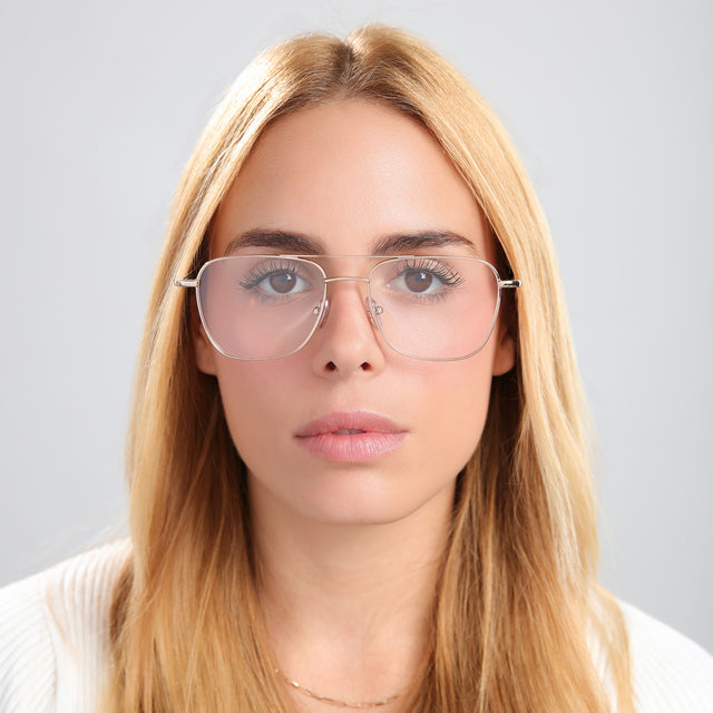 Blond woman in a white knit top wearing Lafayette Optical Rose Gold Optical