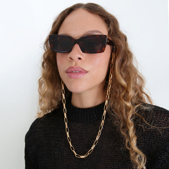 Brunette model with ombré, loose curls wearing Sunglass Chain Large Cable