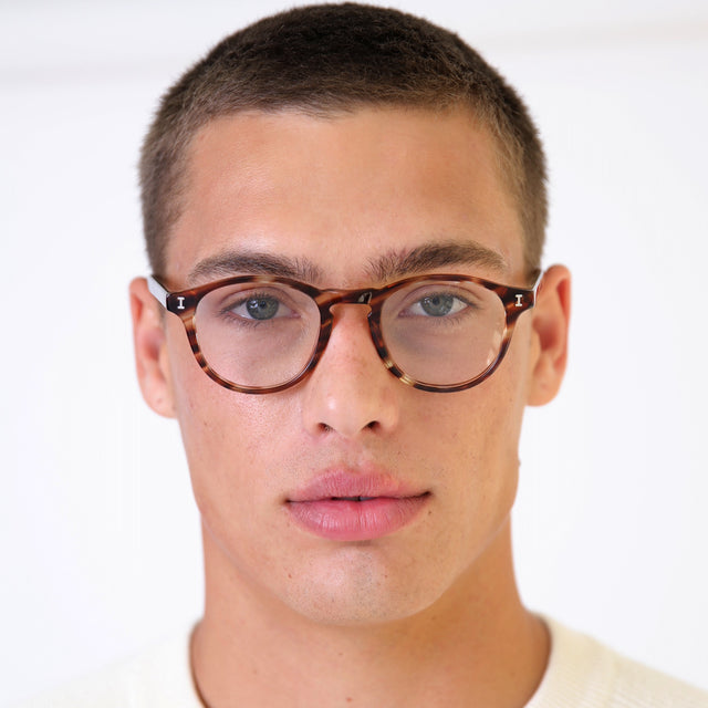 Model with buzzcut hairstyle wearing Lawrence Optical Sand Dune Optical