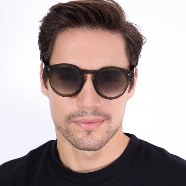Model with short brown hair combed sideways wearing Leonard II E Sunglasses Green with Green Gradient