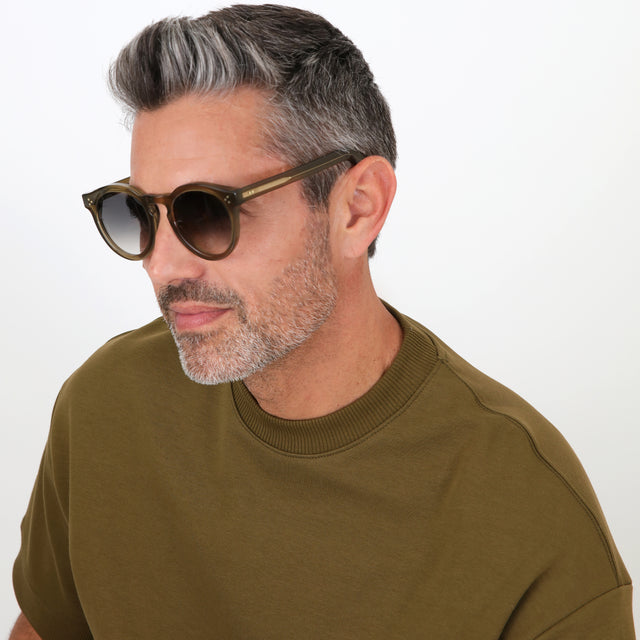 Model with salt and pepper hair and beard wearing Leonard II E Sunglasses Green with Green Gradient