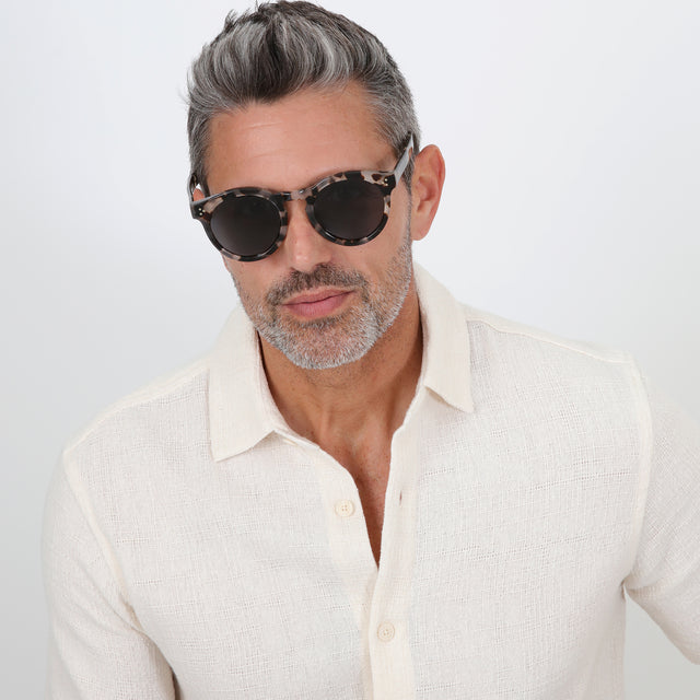 Model with salt and pepper hair and beard wearing Leonard II E Sunglasses White Tortoise Grey