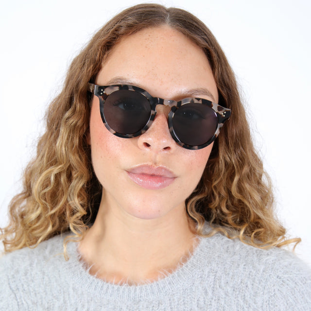 Brunette model with ombré wavy hair wearing Leonard II E Sunglasses White Tortoise with Grey