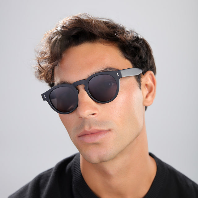 Man in a black tee wearing Leonard Polarized Sunglasses Matte Black with Grey Polarized