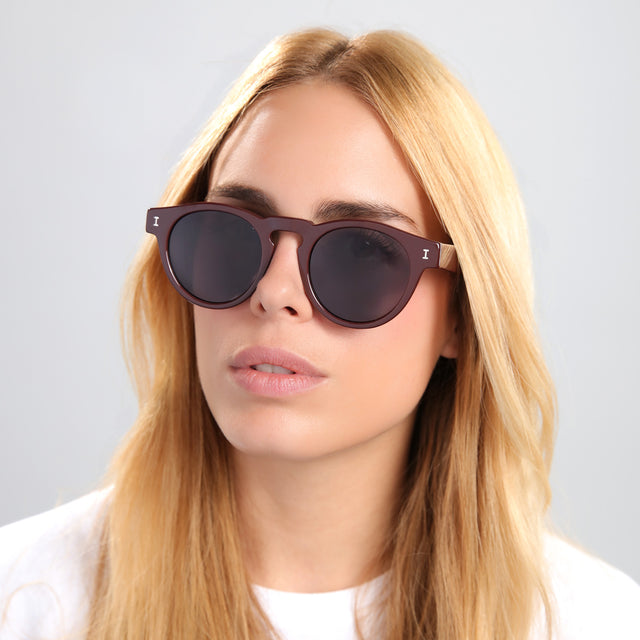Another angle of blond woman in a white tee wearing Leonard Sunglasses Bordeaux with Grey
