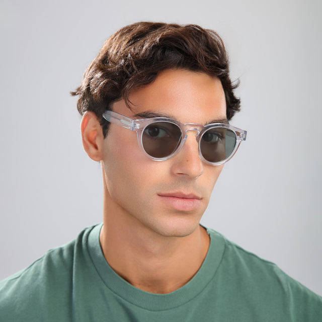 Another angle of man with brown hair in a green tee wearing Leonard Sunglasses Clear with Olive