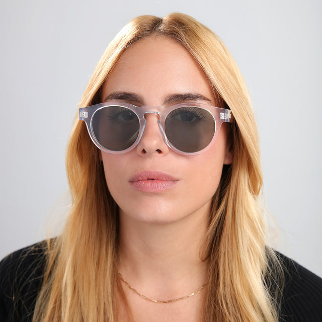 Blonde woman in a black tee wearing Leonard Sunglasses Clear with Olive