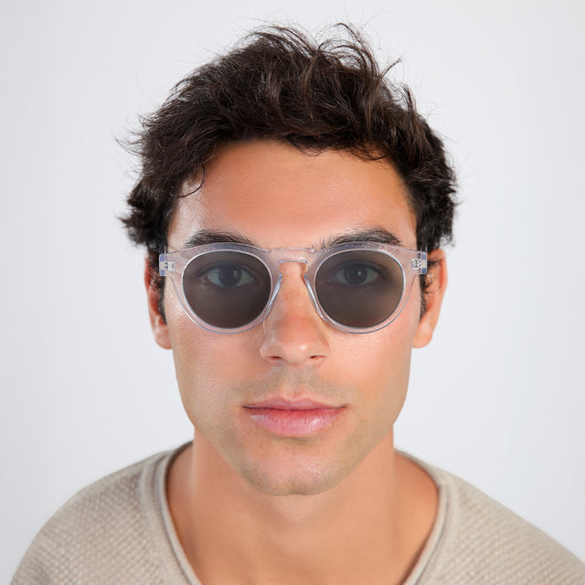 Another angle of man with brown hair in a beige waffled sweatshirt wearing Leonard Sunglasses Clear with Olive