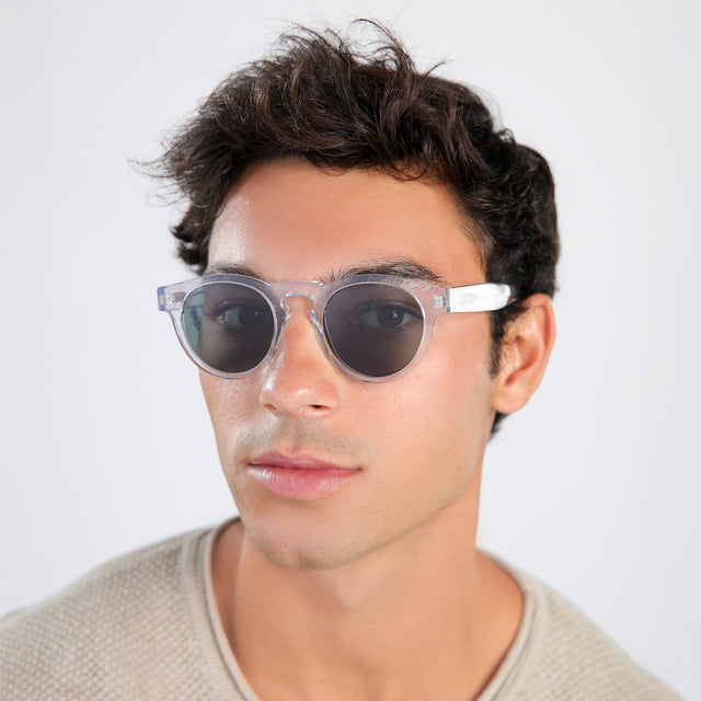 Man with brown hair in a beige waffled sweatshirt wearing Leonard Sunglasses Clear with Olive