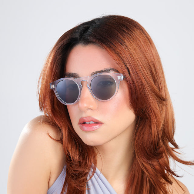 Woman with red hair in a periwinkle blouse wearing Leonard Sunglasses Clear with Olive