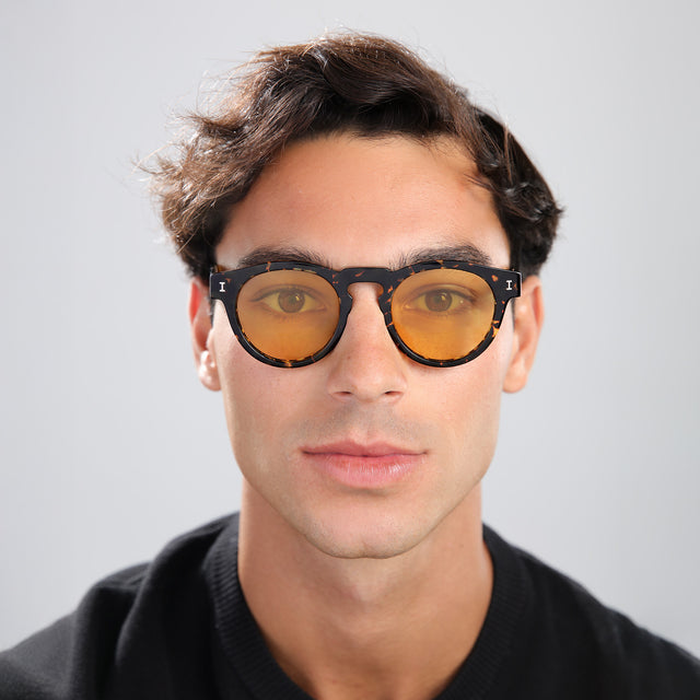 Man in a black tee wearing Leonard Sunglasses Flame with Honey See Through