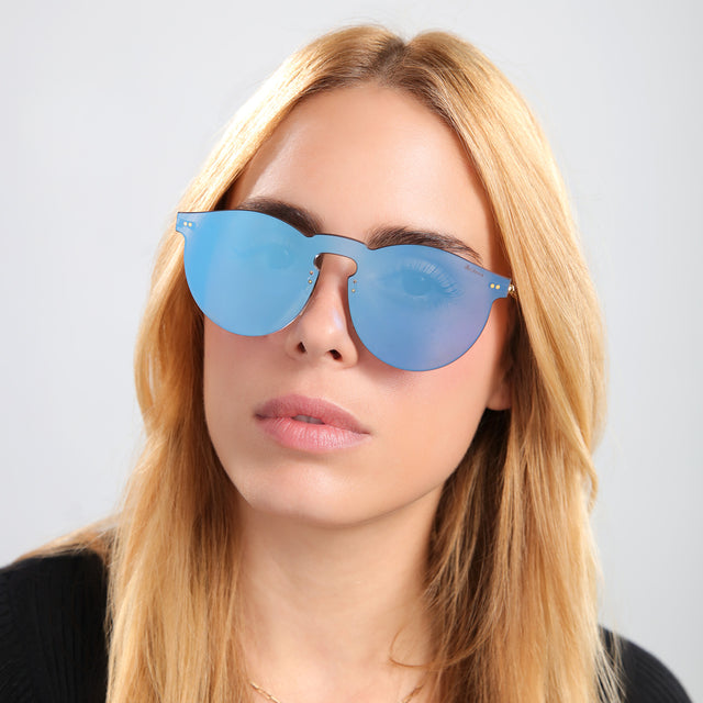 Another angle of blond woman in a black tee wearing Leonard Mask Sunglasses Cobalt with Cobalt