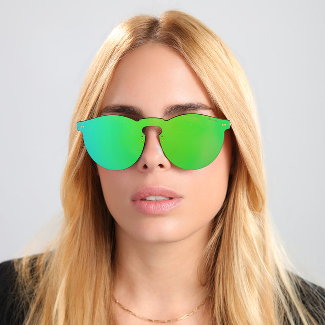 Blond woman in a black tee wearing Leonard Mask Sunglasses Emerald with Emerald
