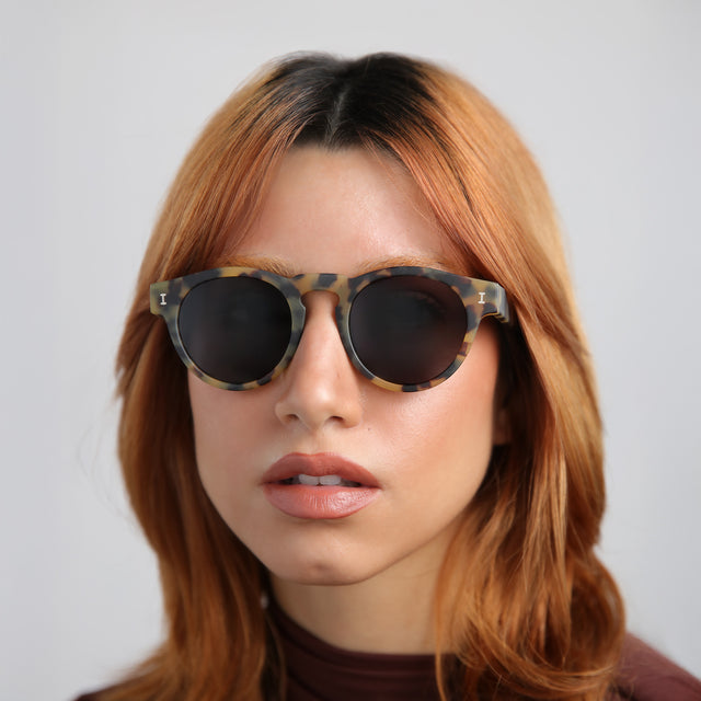 Woman with red hair in a mockneck blouse wearing Leonard Polarized Sunglasses Matte Tortoise with Grey Polarized