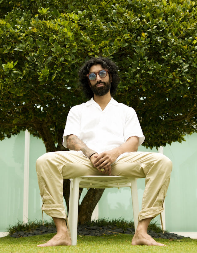Man on a chair near a tree wearing the Leonard Sunglasses