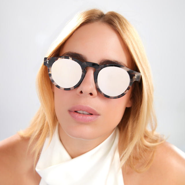 Another angle of blond woman in a silk white halter top wearing Leonard Sunglasses White Tortoise with Silver Mirror
