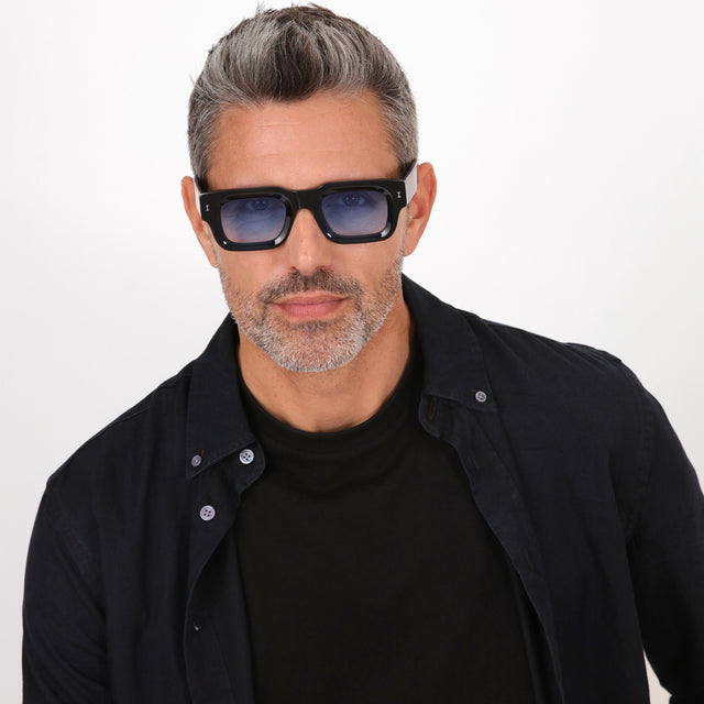 Model with salt and pepper hair and beard wearing Lewis Sunglasses Black with Blue Flat Gradient See Through