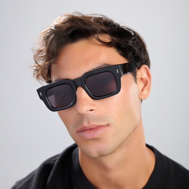 Another angle of man with brown hair in a black shirt wearing Lewis 50 Sunglasses Black with Grey Flat