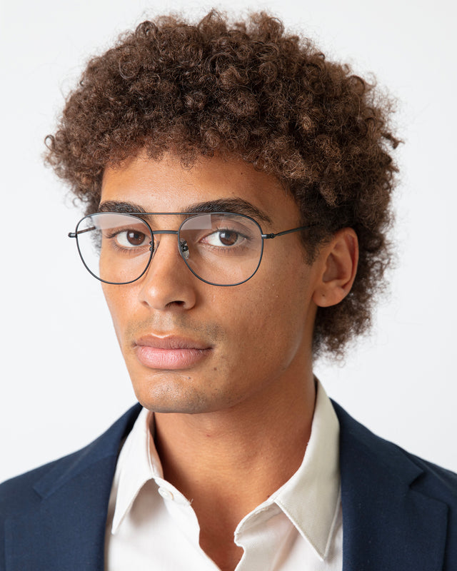 Model with short brown hair wearing Limassol Optical Matte Black Optical
