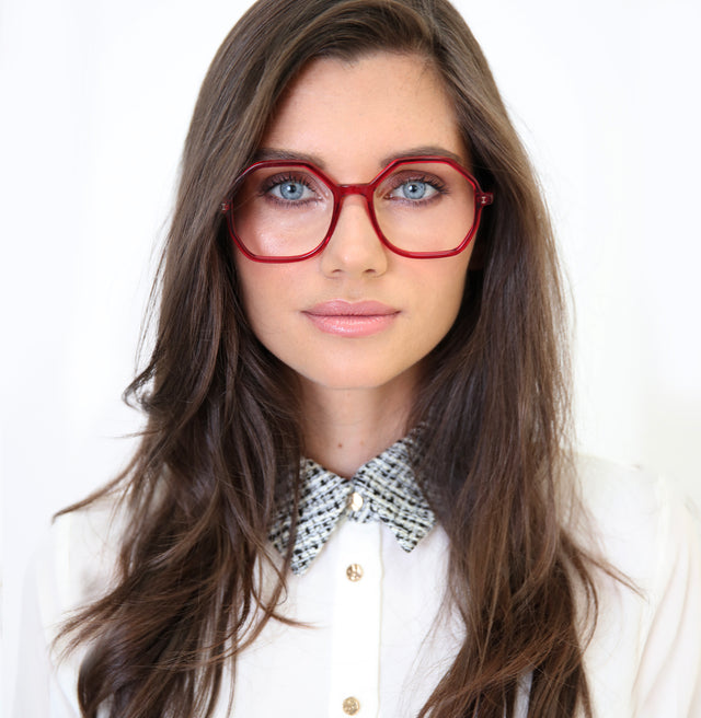 Brunette model with a collared blouse wearing Magdalena Optical Mulberry Optical