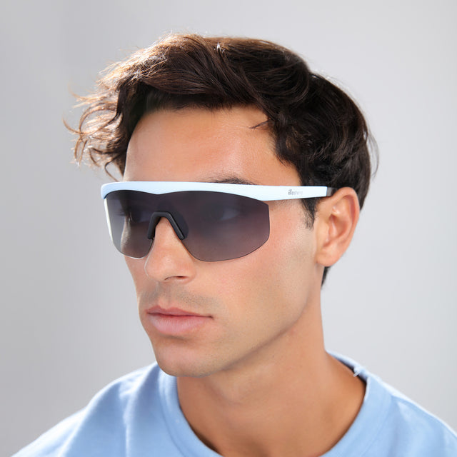 Man in a blue shirt wearing Managua Sunglasses Matte Baby Blue with Grey Gradient