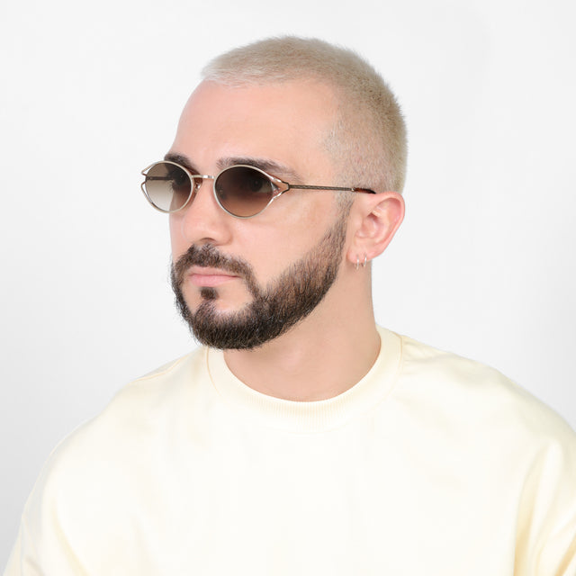 Bearded model looking right wearing Maria Sunglasses Rose Gold with Taupe Gradient