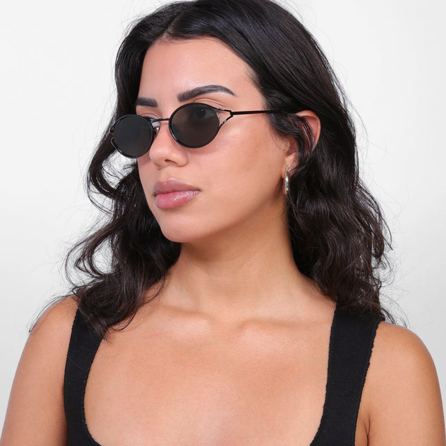 Brunette model looking right wearing Maria Sunglasses Black with Grey