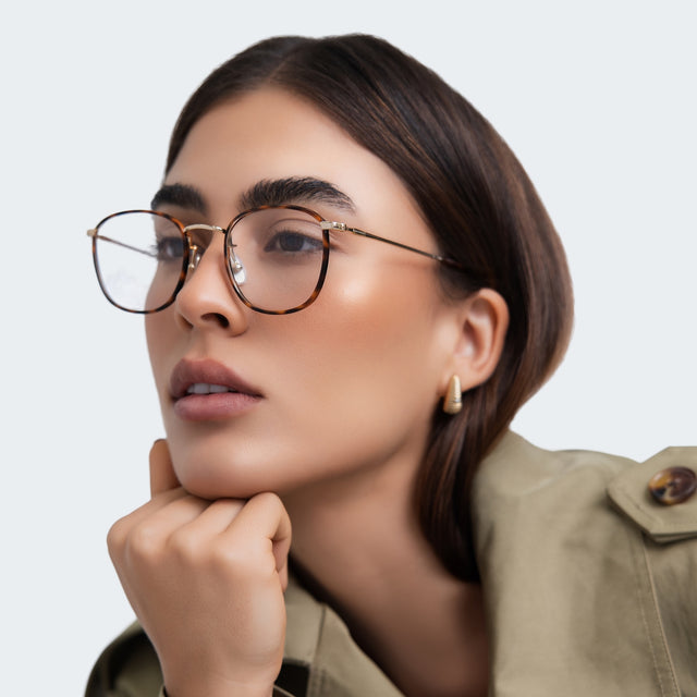 Another angle of woman in a trench coat wearing Mayfair Optical Havana/Gold Optical
