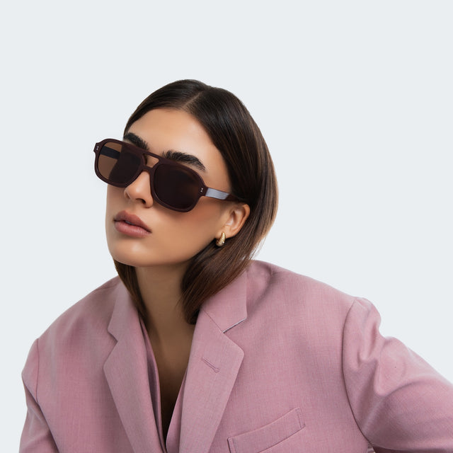 Woman in a pink blazer wearing Memphis Sunglasses Bordeaux with Brown