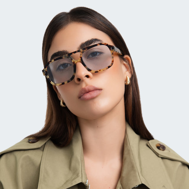 Woman in a trench coat wearing Memphis Sunglasses Tortoise with Light Blue See Through