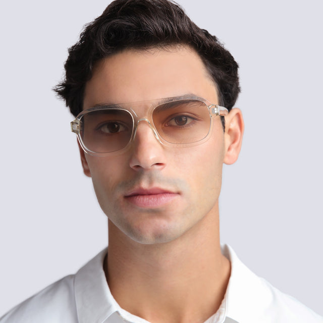 Man in a white shirt wearing Memphis 57 Sunglasses Champagne with Taupe Gradient