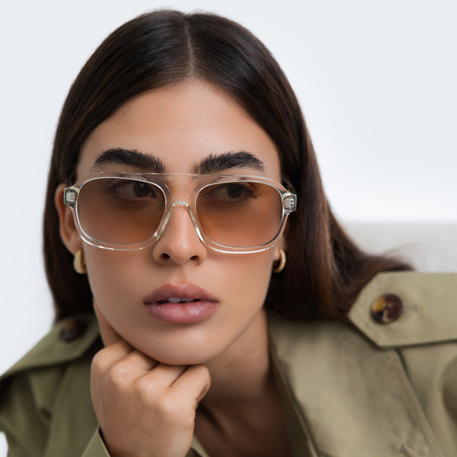Close up of woman in a trench coat wearing Memphis 57 Sunglasses Champagne with Taupe Gradient