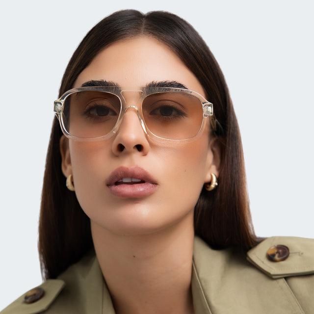 Woman in a trench coat wearing Memphis 57 Sunglasses Champagne with Taupe Gradient