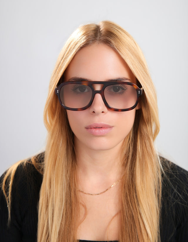 Blond woman in a black blouse wearing the Memphis in Havana with Taupe Gradient lenses