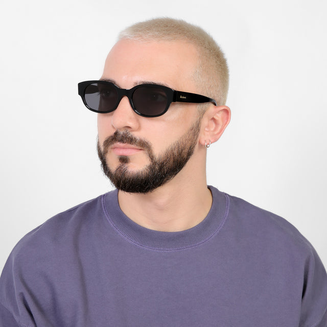 Bearded model looking right wearing Montreal E Sunglasses Black with Grey Flat