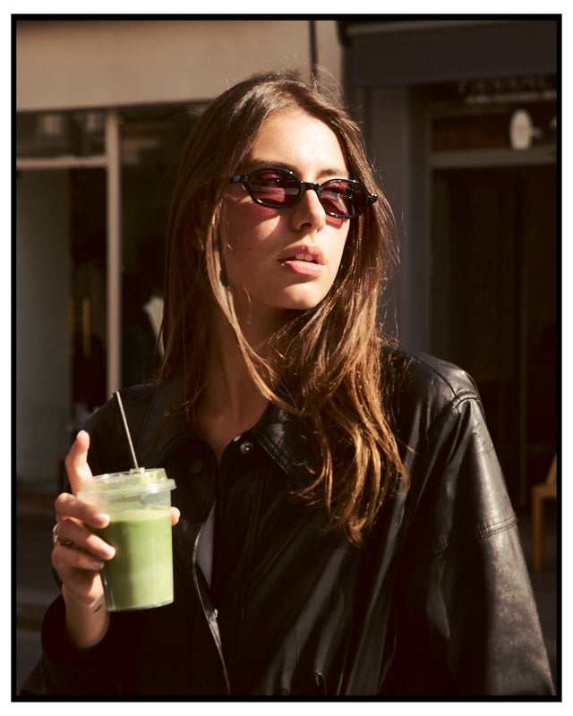 Woman wearing the Munich Sunglasses in Black with Plum See Through