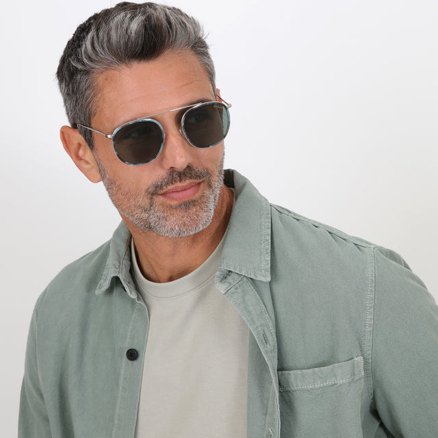 Model with salt and pepper hair and beard wearing Mykonos Ace Sunglasses Dark Ice/Silver with Olive Flat