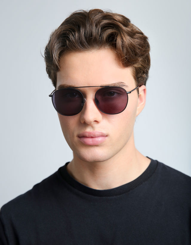 Man in a black tee wearing the Mykonos II in Matte Black with Grey