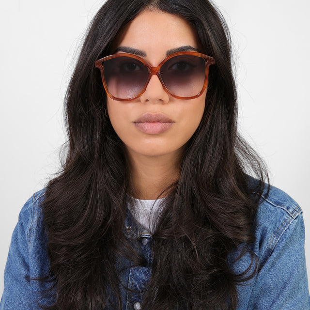 Brunette model in a denim jacket wearing Nancy 57 Sunglasses Red Havana with Grey Gradient