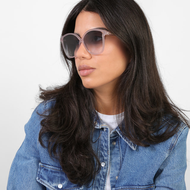 Brunette model in a denim jacket looking right wearing Nancy 57 Sunglasses Thistle with Grey Gradient