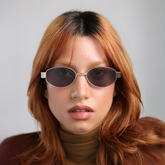 Model with red hair wearing Nesso Sunglasses Gold with Grey