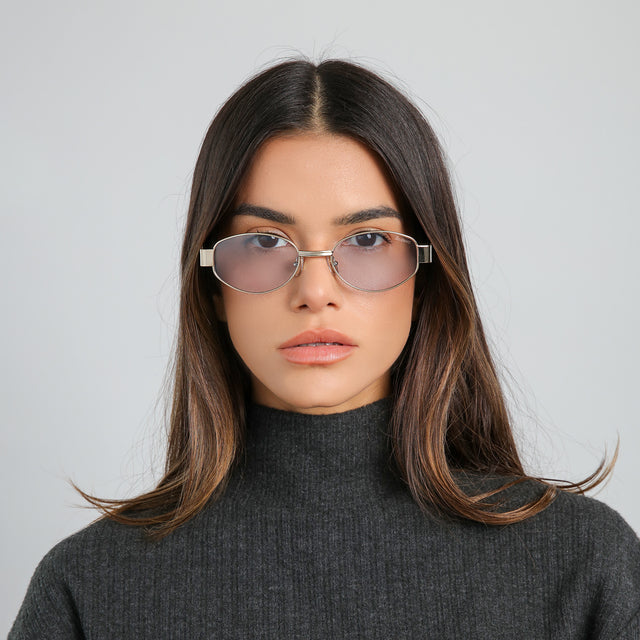 Model with brown hair in a cashmere top wearing Nesso Sunglasses Gold with Light Blue See Through