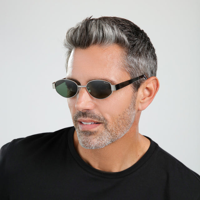 Bearded model looking right wearing Nesso Sunglasses Silver with Olive