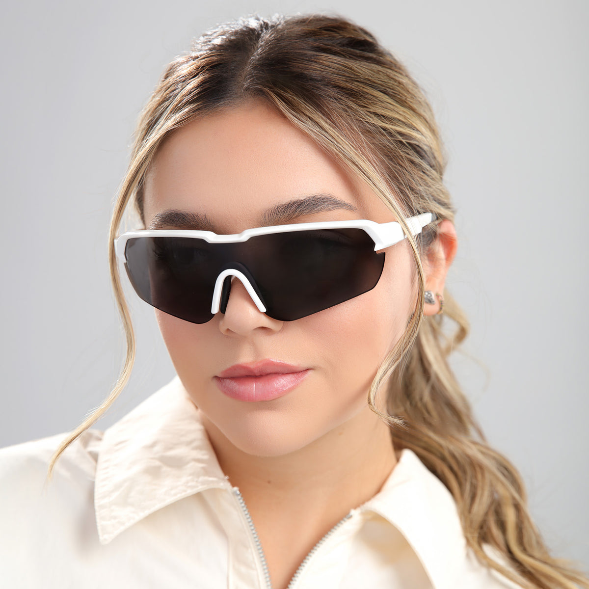 Woman wearing Nicaragua Sunglasses in White with Grey Polarized lenses, front view, Brunette model with highlights
