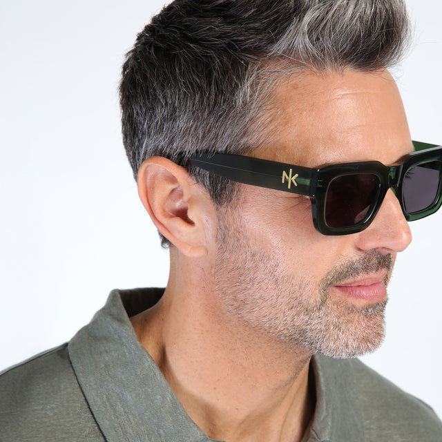 Close up of model with salt and pepper hair and beard wearing Nick Kyrgios x illesteva 2 Sunglasses Pine with Grey Flat